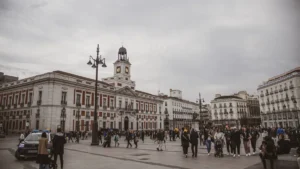 Crowds in Puerta del Sol, Madrid, with the Royal House of the Post Office clock tower